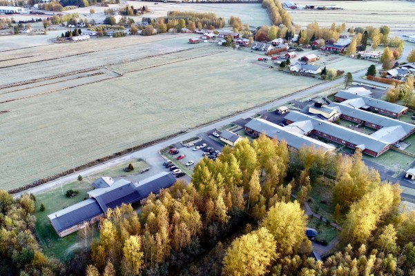 Syksyinen ilmakuva ajankohtaisesta asema-kaava-alueelta Pännäisissä. Peltoja, taloja ja Skrufvilakatu.